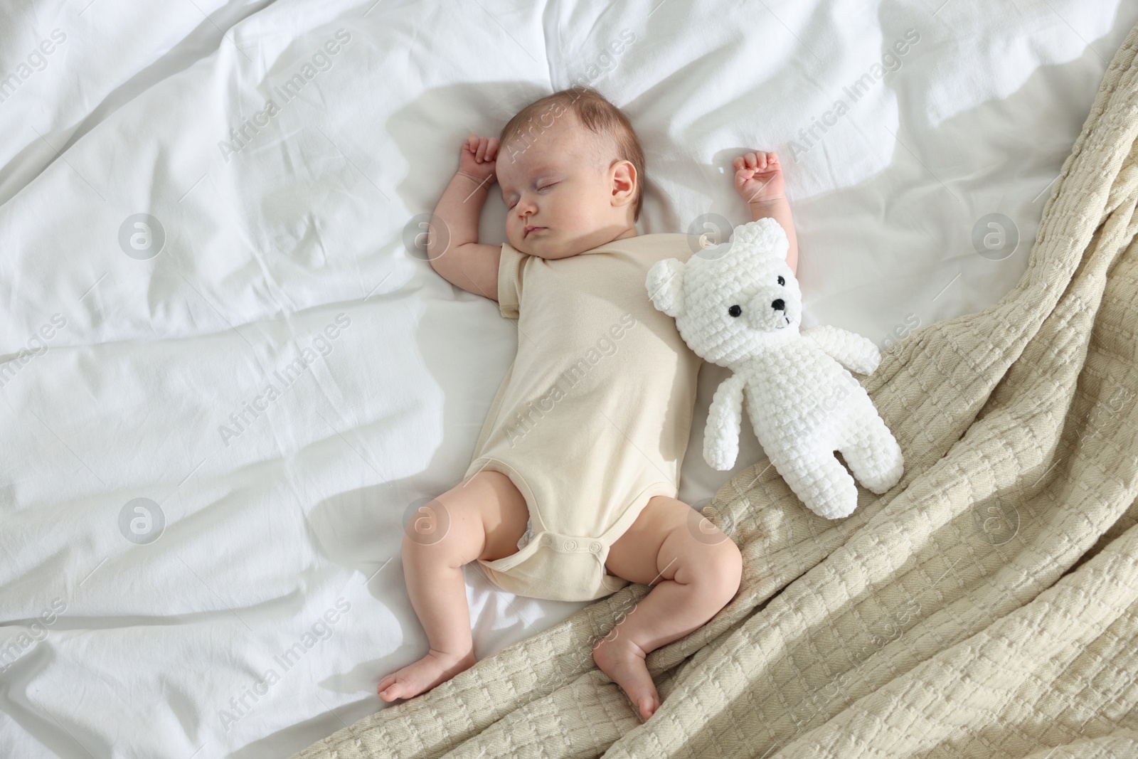 Cute newborn baby sleeping on bed indoors, top view Photo of Cute newborn baby sleeping on bed indoors, top view