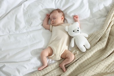 Photo of Cute newborn baby sleeping on bed indoors, top view