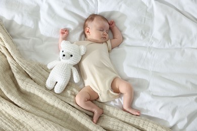 Photo of Cute newborn baby sleeping on bed indoors, top view