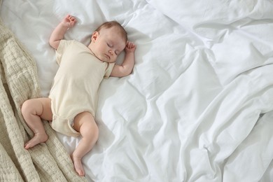 Photo of Cute newborn baby sleeping on bed indoors, top view. Space for text