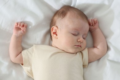 Photo of Cute newborn baby sleeping on bed indoors, top view
