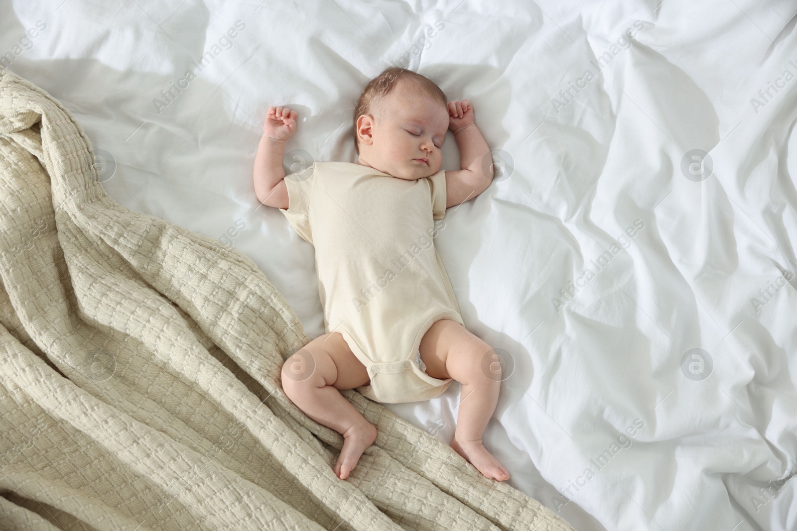 Cute newborn baby sleeping on bed indoors, top view Photo of Cute newborn baby sleeping on bed indoors, top view