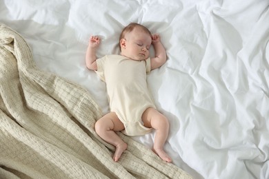Photo of Cute newborn baby sleeping on bed indoors, top view
