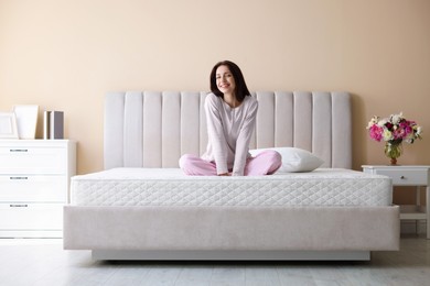 Photo of Woman on bed with orthopedic mattress at home