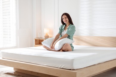 Photo of Woman on bed with soft mattress at home
