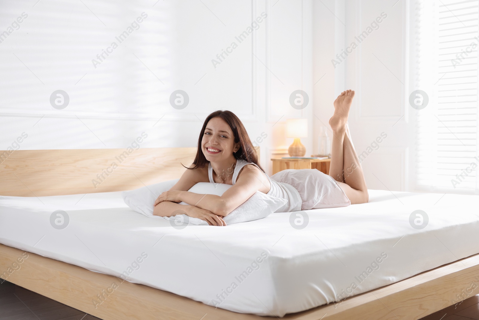 Woman lying on bed with orthopedic mattress at home Photo of Woman lying on bed with orthopedic mattress at home