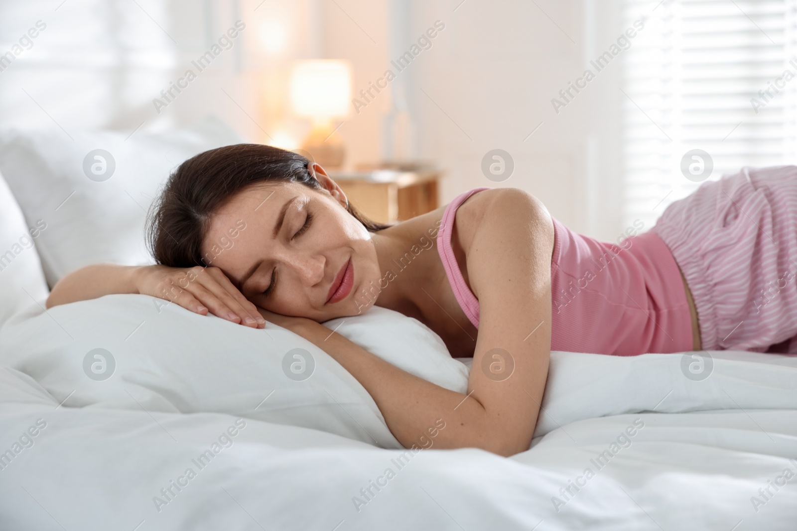 Woman sleeping on bed with soft mattress at home Photo of Woman sleeping on bed with soft mattress at home
