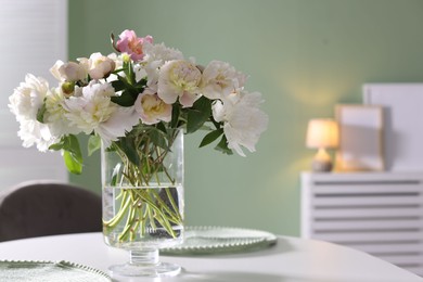Photo of Beautiful table setting with vase of flowers in dining room, space for text