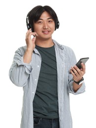Photo of Handsome Asian man in headphones with smartphone on white background