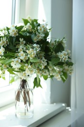 Photo of Beautiful jasmine flowers in vase near window indoors, closeup