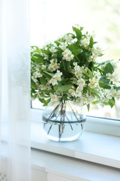 Photo of Beautiful jasmine flowers in vase near window indoors