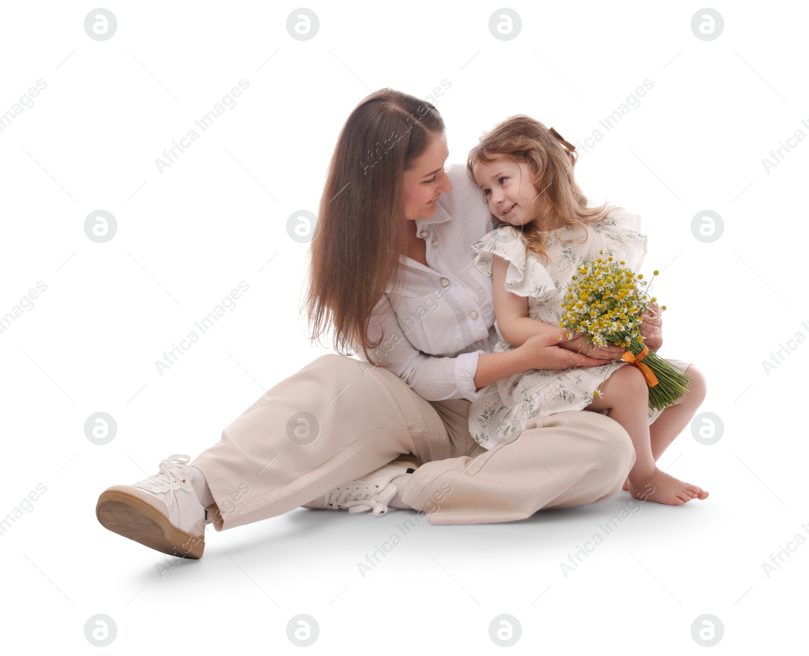 Mother and her little daughter with bouquet of beautiful chamomile flowers on white background Photo of Mother and her little daughter with bouquet of beautiful chamomile flowers on white background
