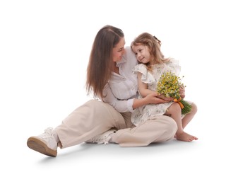 Photo of Mother and her little daughter with bouquet of beautiful chamomile flowers on white background