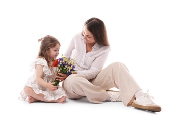 Photo of Mother and her little daughter with bouquet of beautiful flowers on white background