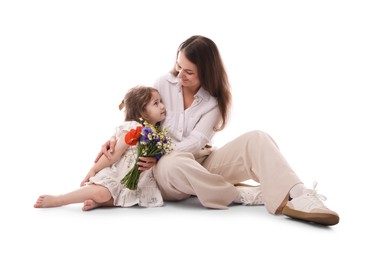 Photo of Mother and her little daughter with bouquet of beautiful flowers on white background