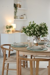 Photo of Bouquet of beautiful jasmine flowers on dining table indoors
