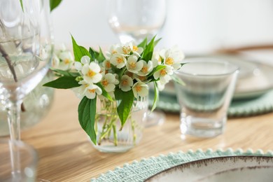Photo of Beautiful jasmine flowers on dining table indoors, closeup