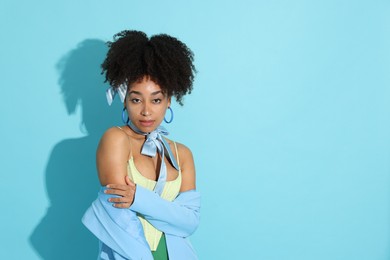 Photo of Fashionable portrait of beautiful Brazilian woman in stylish outfit on light blue background. Space for text