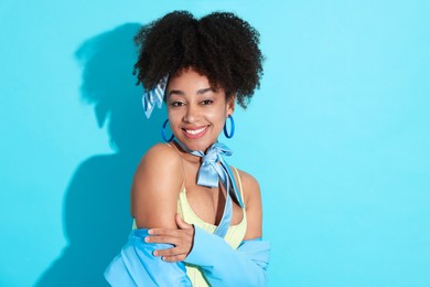 Photo of Fashionable portrait of beautiful Brazilian woman in stylish outfit on light blue background