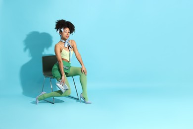 Photo of Fashionable portrait of beautiful Brazilian woman in stylish outfit on light blue background. Space for text