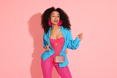 Photo of Fashionable portrait of beautiful Brazilian woman in stylish outfit on pink background