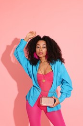 Photo of Fashionable portrait of beautiful Brazilian woman in stylish outfit on pink background