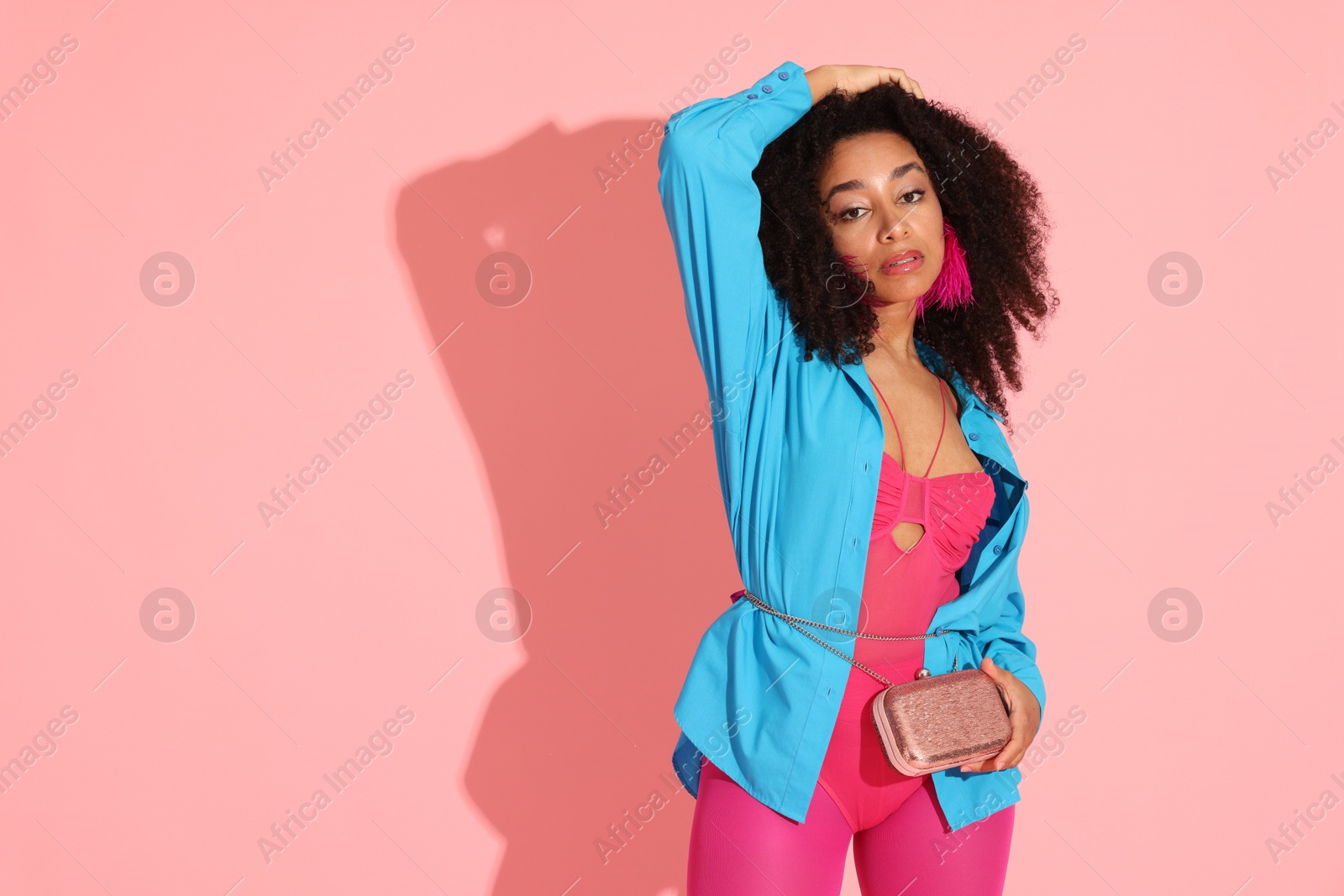 Fashionable portrait of beautiful Brazilian woman in stylish outfit on pink background. Space for text Photo of Fashionable portrait of beautiful Brazilian woman in stylish outfit on pink background. Space for text