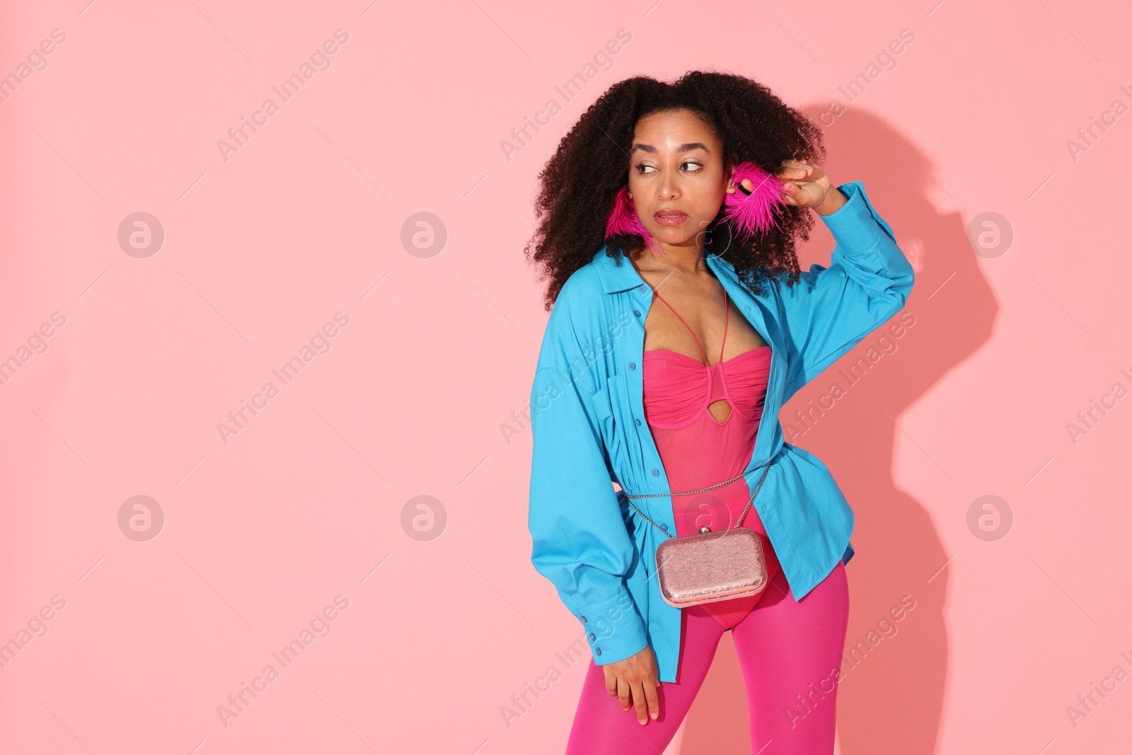 Fashionable portrait of beautiful Brazilian woman in stylish outfit on pink background. Space for text Photo of Fashionable portrait of beautiful Brazilian woman in stylish outfit on pink background. Space for text