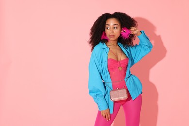 Photo of Fashionable portrait of beautiful Brazilian woman in stylish outfit on pink background. Space for text
