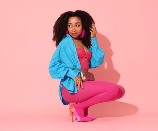 Photo of Fashionable portrait of beautiful Brazilian woman in stylish outfit on pink background