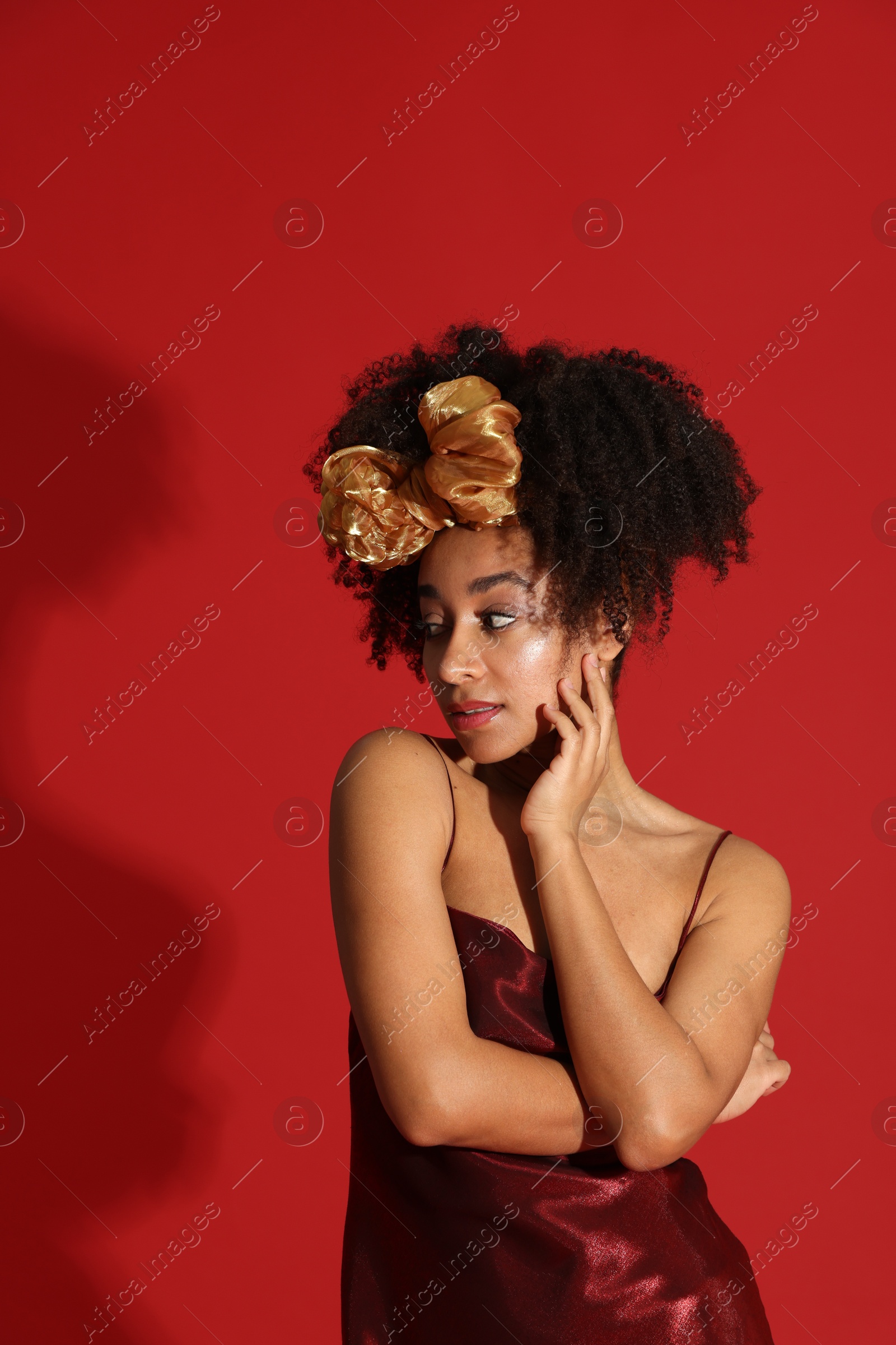 Fashionable portrait of beautiful Brazilian woman in stylish outfit on red background Photo of Fashionable portrait of beautiful Brazilian woman in stylish outfit on red background