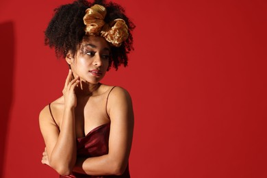 Photo of Fashionable portrait of beautiful Brazilian woman in stylish outfit on red background. Space for text
