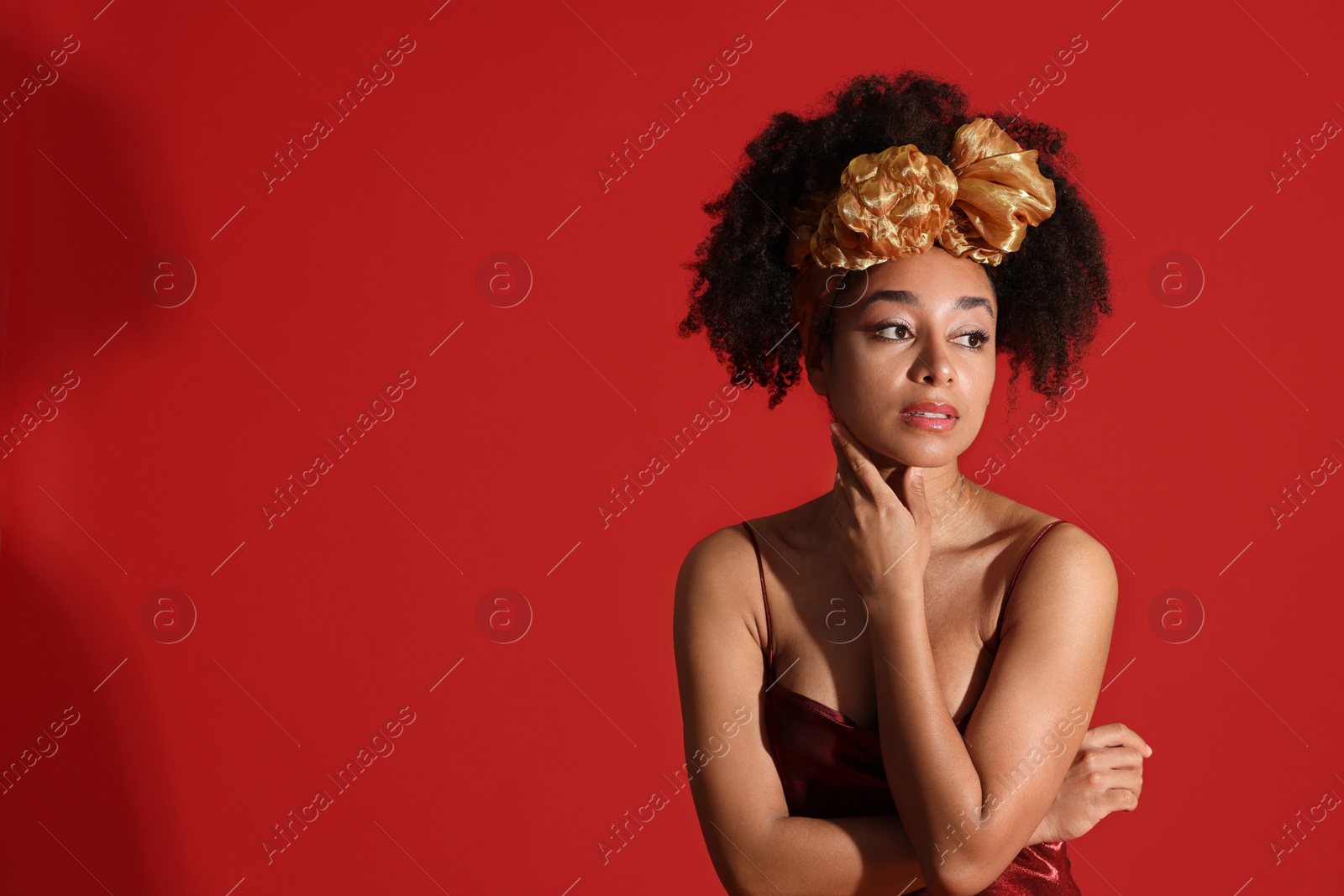 Fashionable portrait of beautiful Brazilian woman in stylish outfit on red background. Space for text Photo of Fashionable portrait of beautiful Brazilian woman in stylish outfit on red background. Space for text