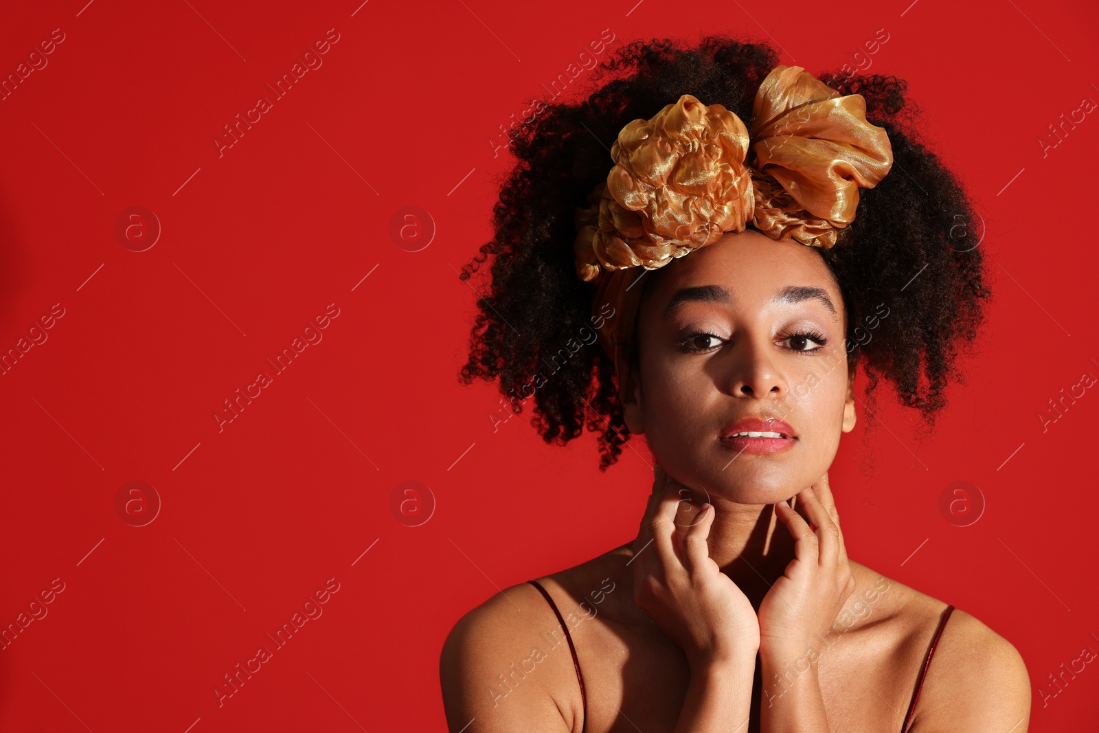 Fashionable portrait of beautiful Brazilian woman in stylish outfit on red background. Space for text Photo of Fashionable portrait of beautiful Brazilian woman in stylish outfit on red background. Space for text
