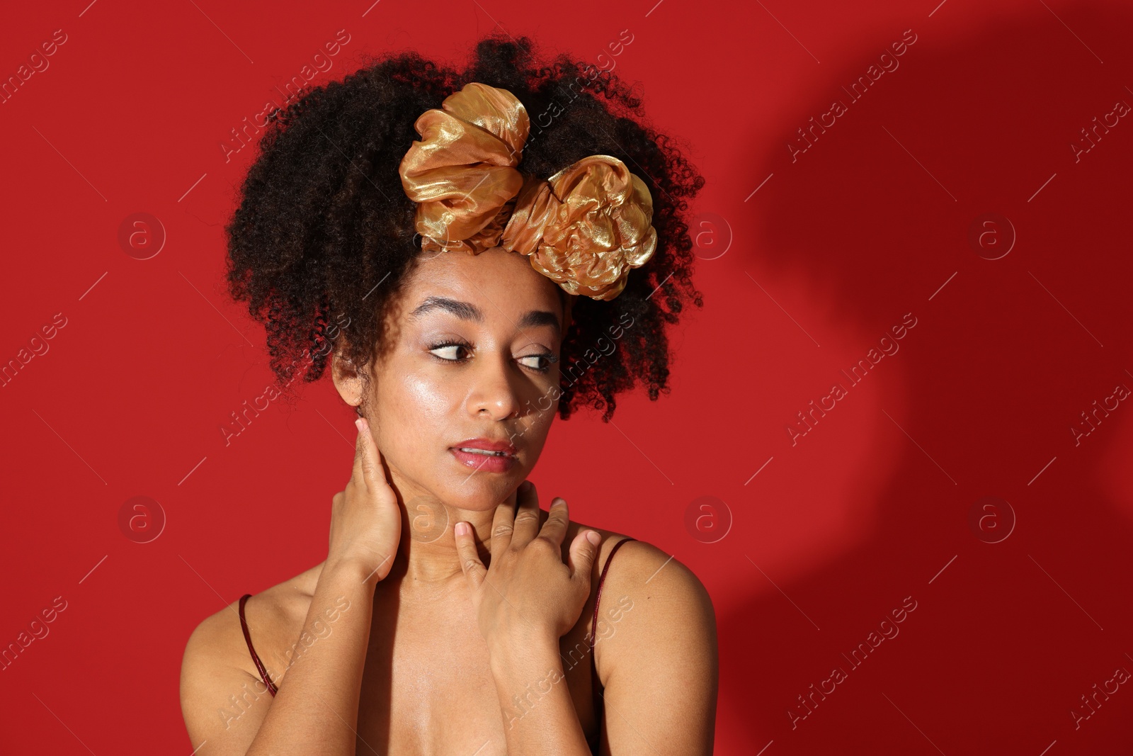 Fashionable portrait of beautiful Brazilian woman in stylish outfit on red background. Space for text Photo of Fashionable portrait of beautiful Brazilian woman in stylish outfit on red background. Space for text