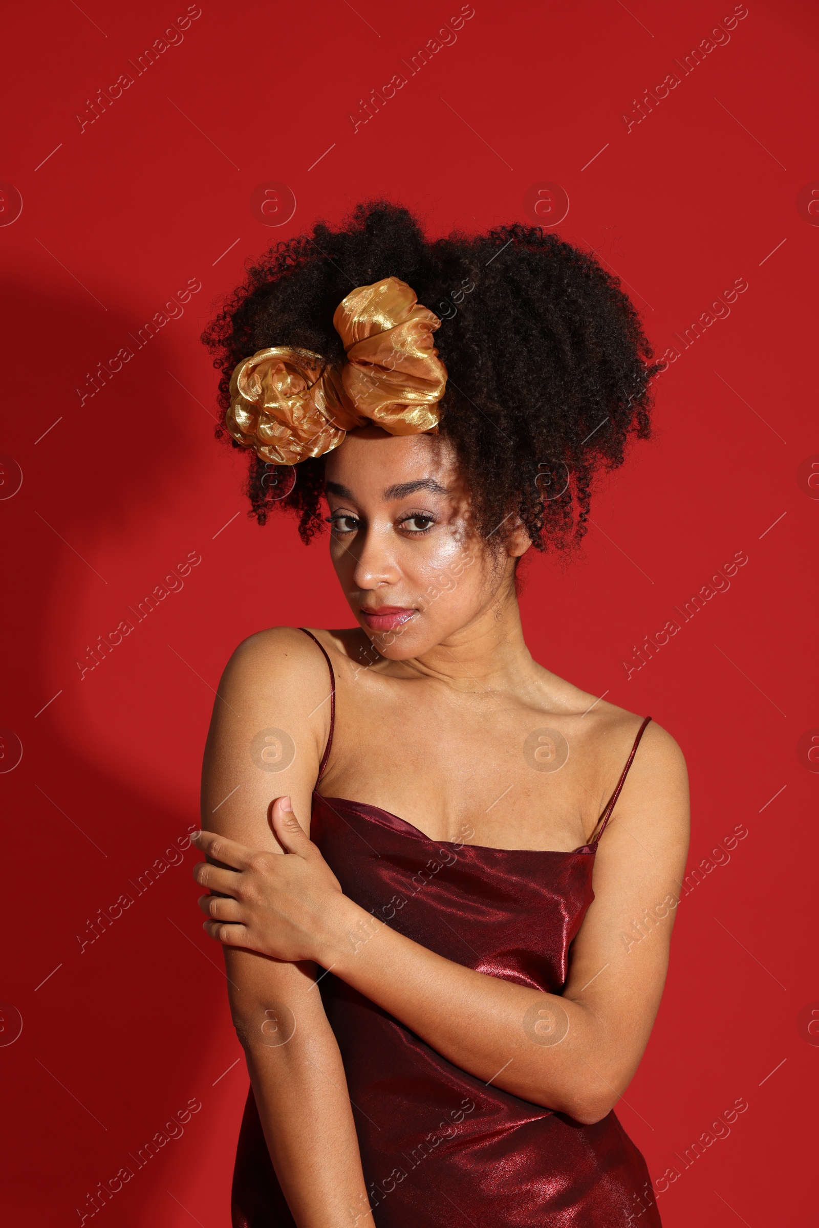 Fashionable portrait of beautiful Brazilian woman in stylish outfit on red background Photo of Fashionable portrait of beautiful Brazilian woman in stylish outfit on red background