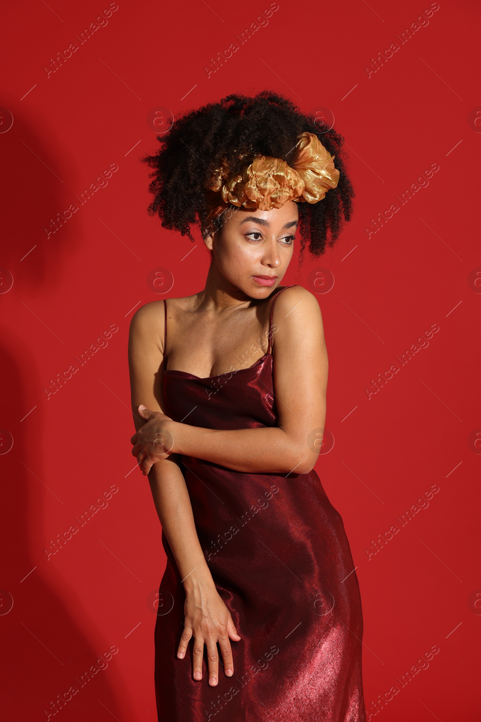 Fashionable portrait of beautiful Brazilian woman in stylish outfit on red background Photo of Fashionable portrait of beautiful Brazilian woman in stylish outfit on red background