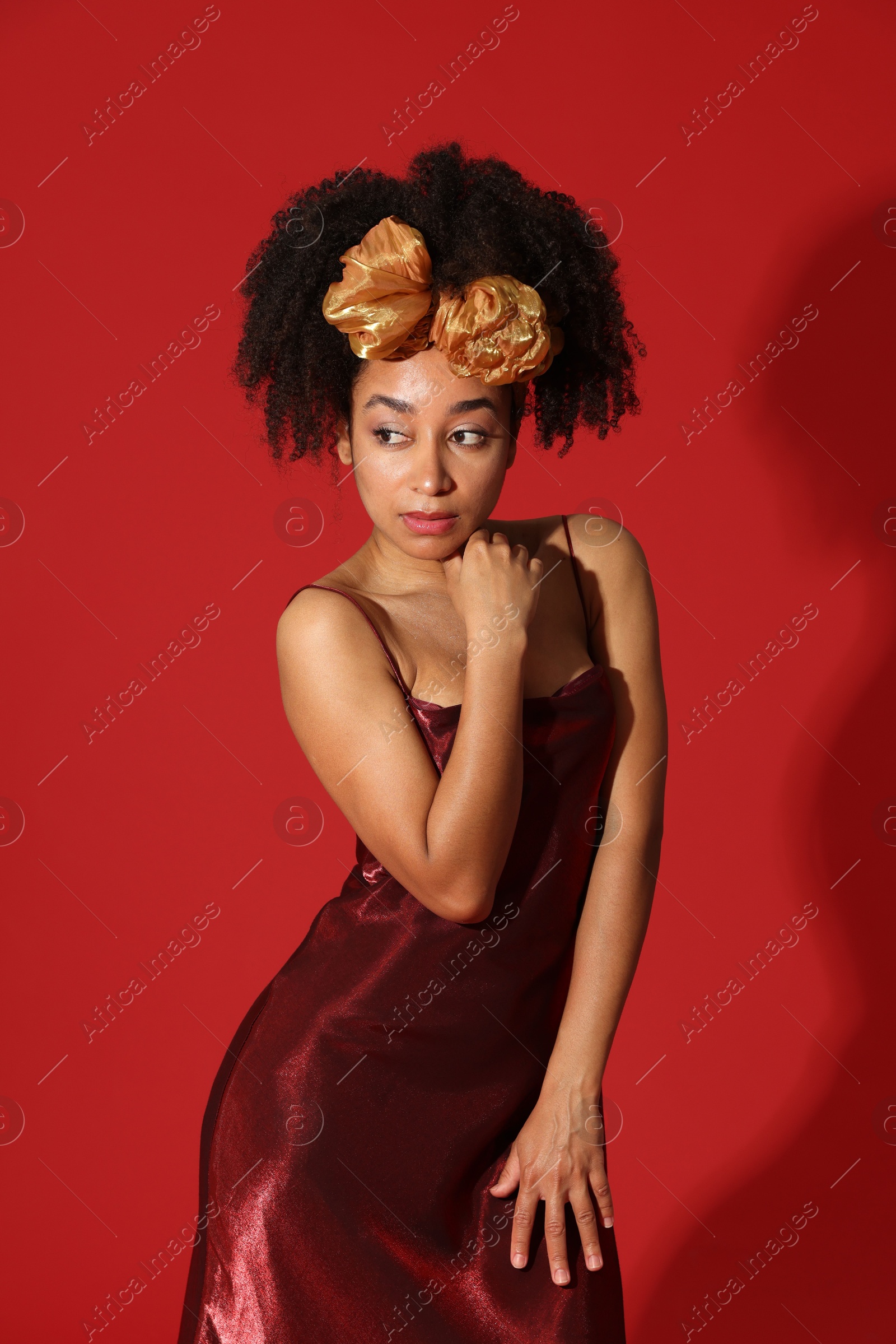 Fashionable portrait of beautiful Brazilian woman in stylish outfit on red background Photo of Fashionable portrait of beautiful Brazilian woman in stylish outfit on red background