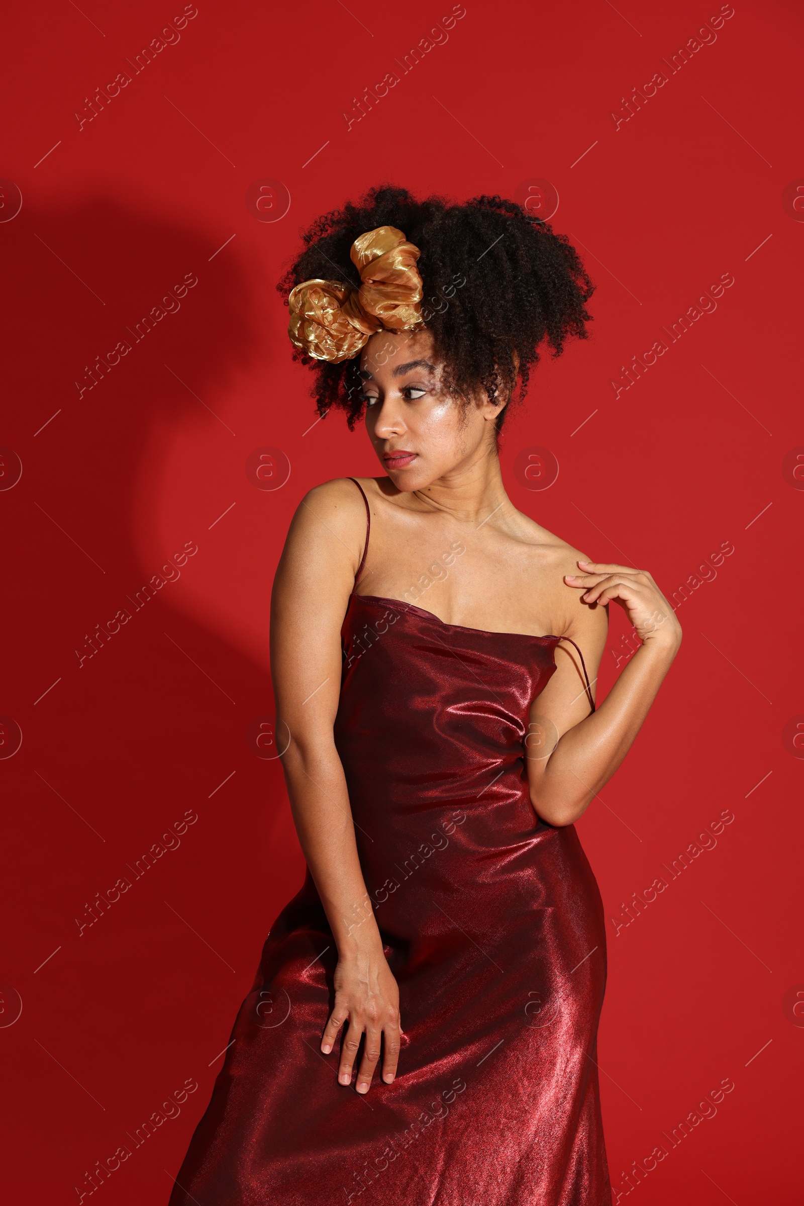 Fashionable portrait of beautiful Brazilian woman in stylish outfit on red background Photo of Fashionable portrait of beautiful Brazilian woman in stylish outfit on red background