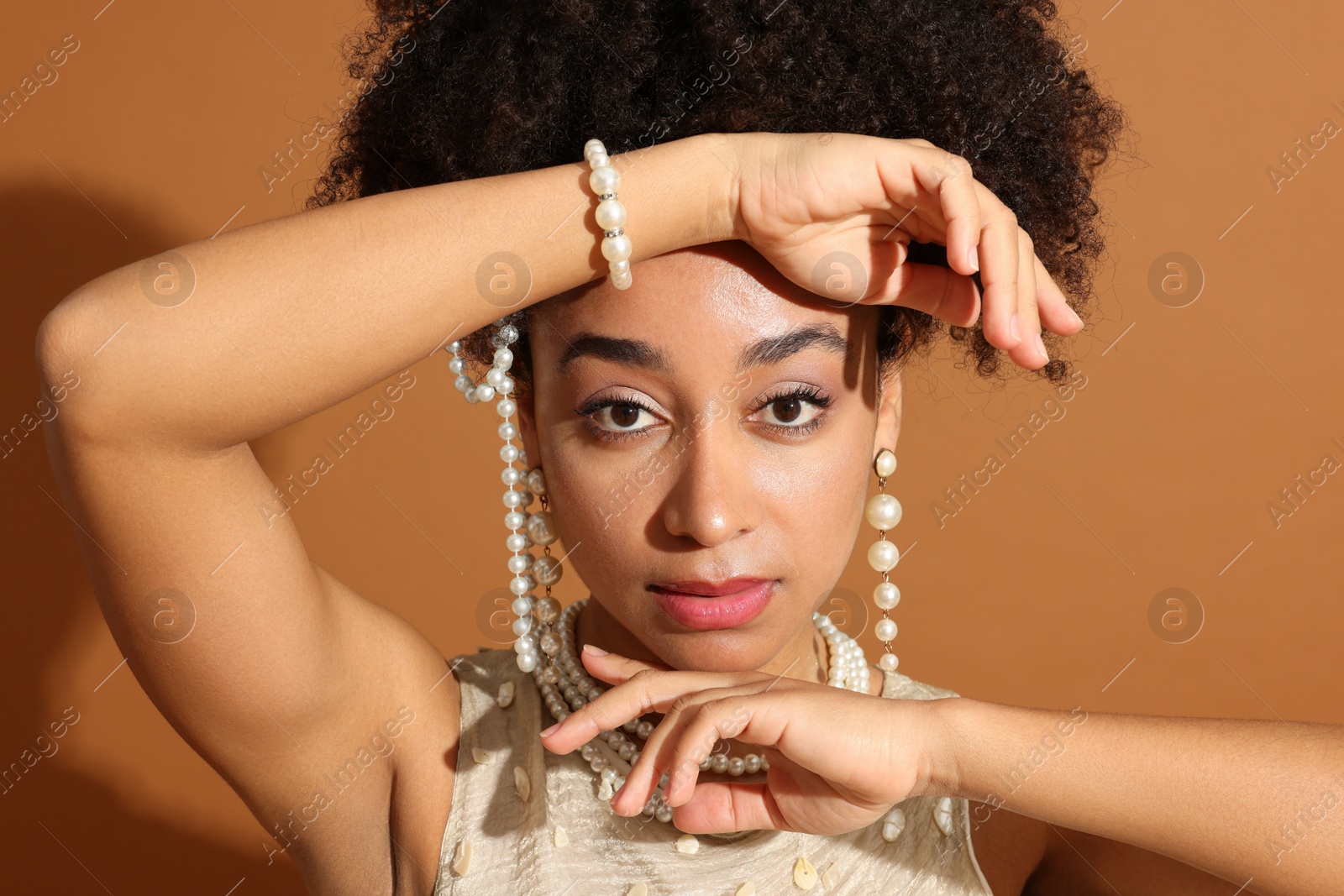 Fashionable portrait of beautiful Brazilian woman in stylish outfit on light brown background, closeup Photo of Fashionable portrait of beautiful Brazilian woman in stylish outfit on light brown background, closeup