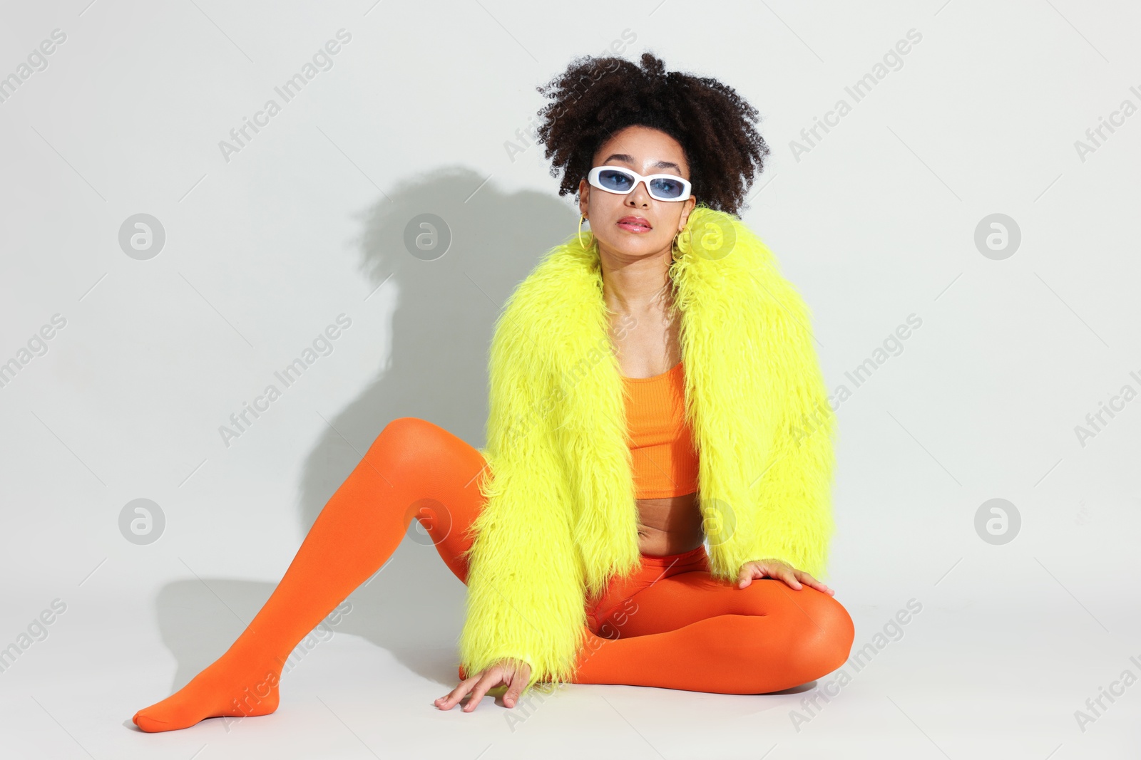 Photo of Fashionable portrait of beautiful Brazilian woman in stylish outfit on white background