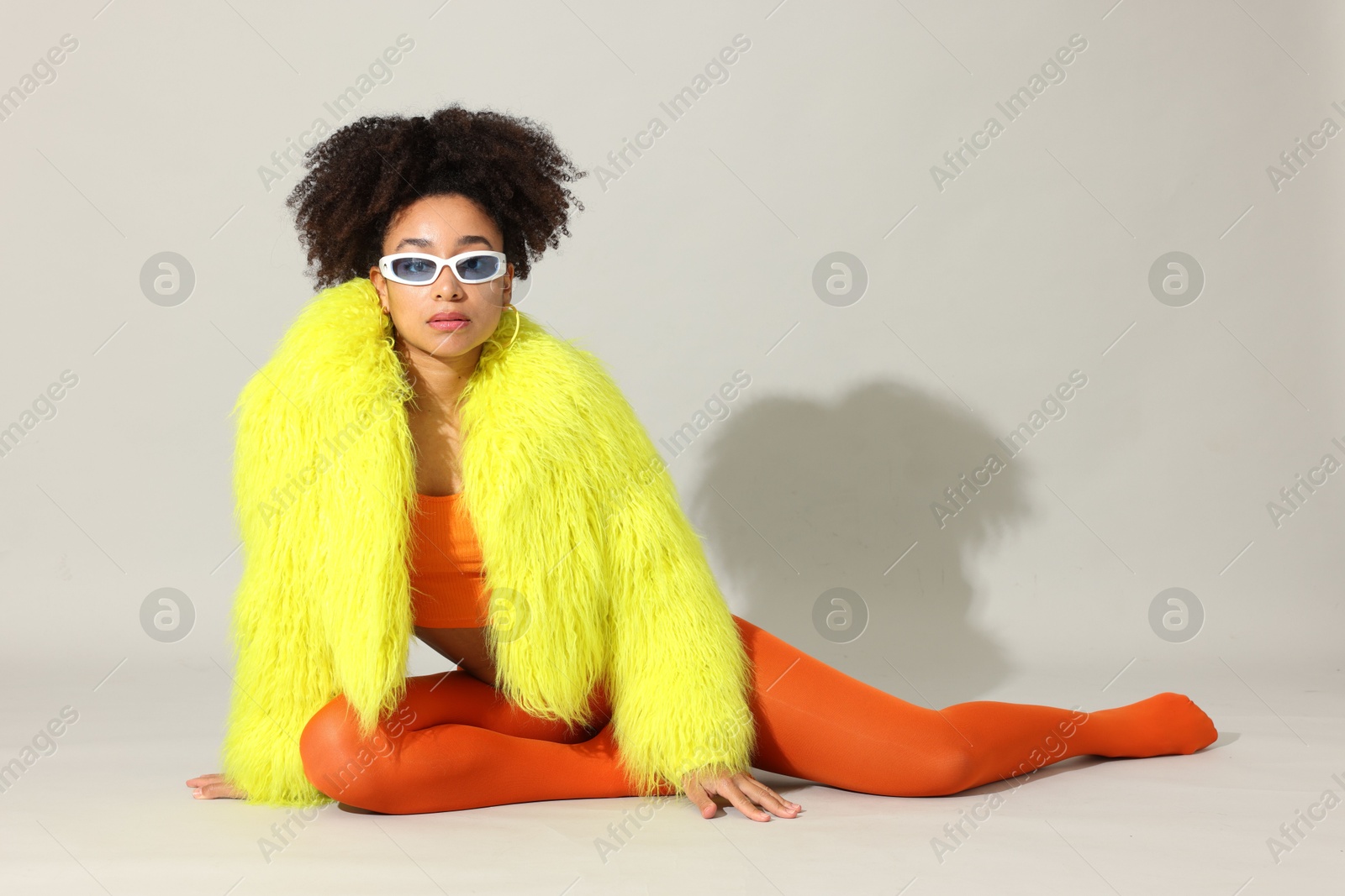 Photo of Fashionable portrait of beautiful Brazilian woman in stylish outfit on white background