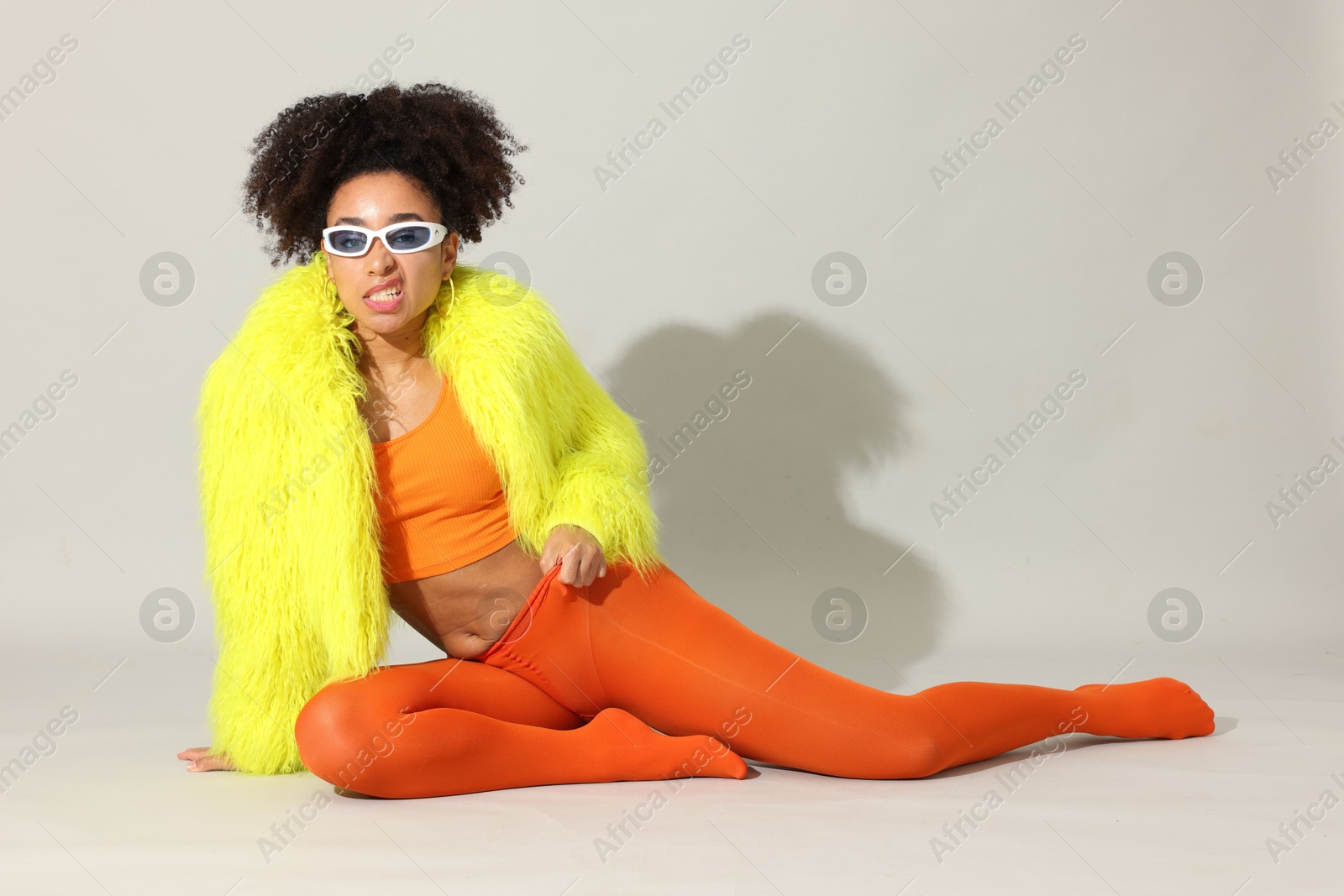 Fashionable portrait of beautiful Brazilian woman in stylish outfit on white background Photo of Fashionable portrait of beautiful Brazilian woman in stylish outfit on white background