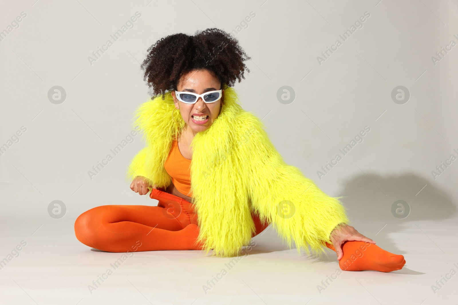 Photo of Fashionable portrait of beautiful Brazilian woman in stylish outfit on white background