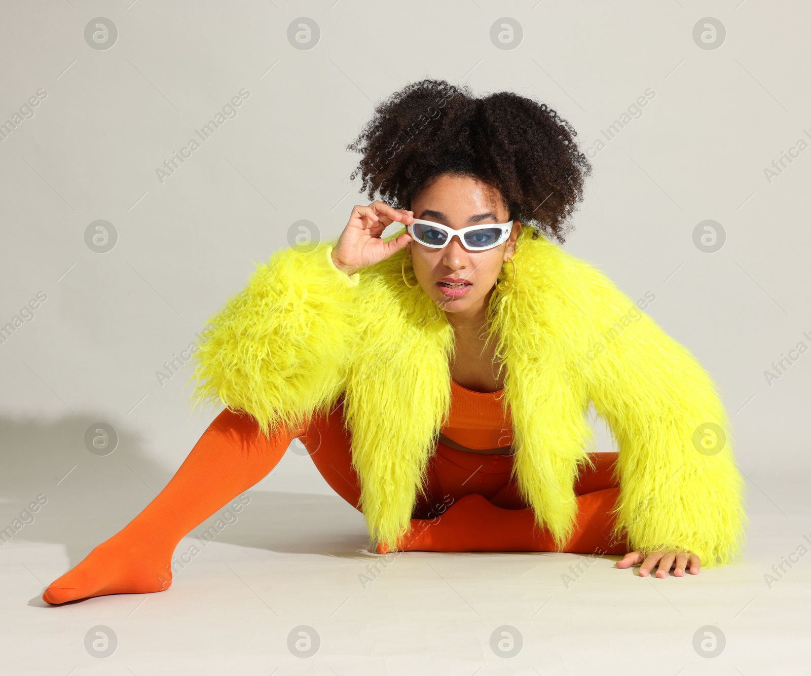 Photo of Fashionable portrait of beautiful Brazilian woman in stylish outfit on white background
