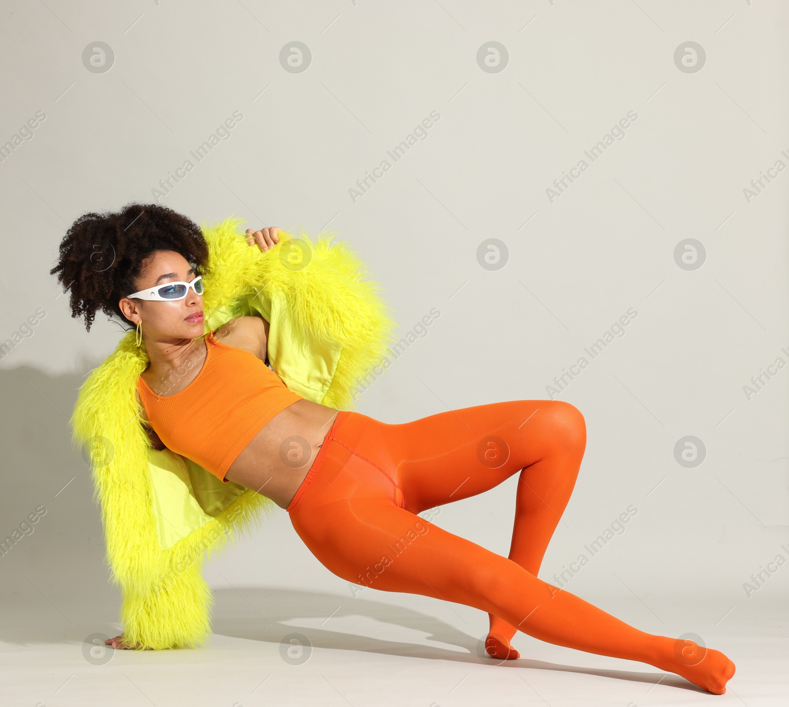 Photo of Fashionable portrait of beautiful Brazilian woman in stylish outfit on white background