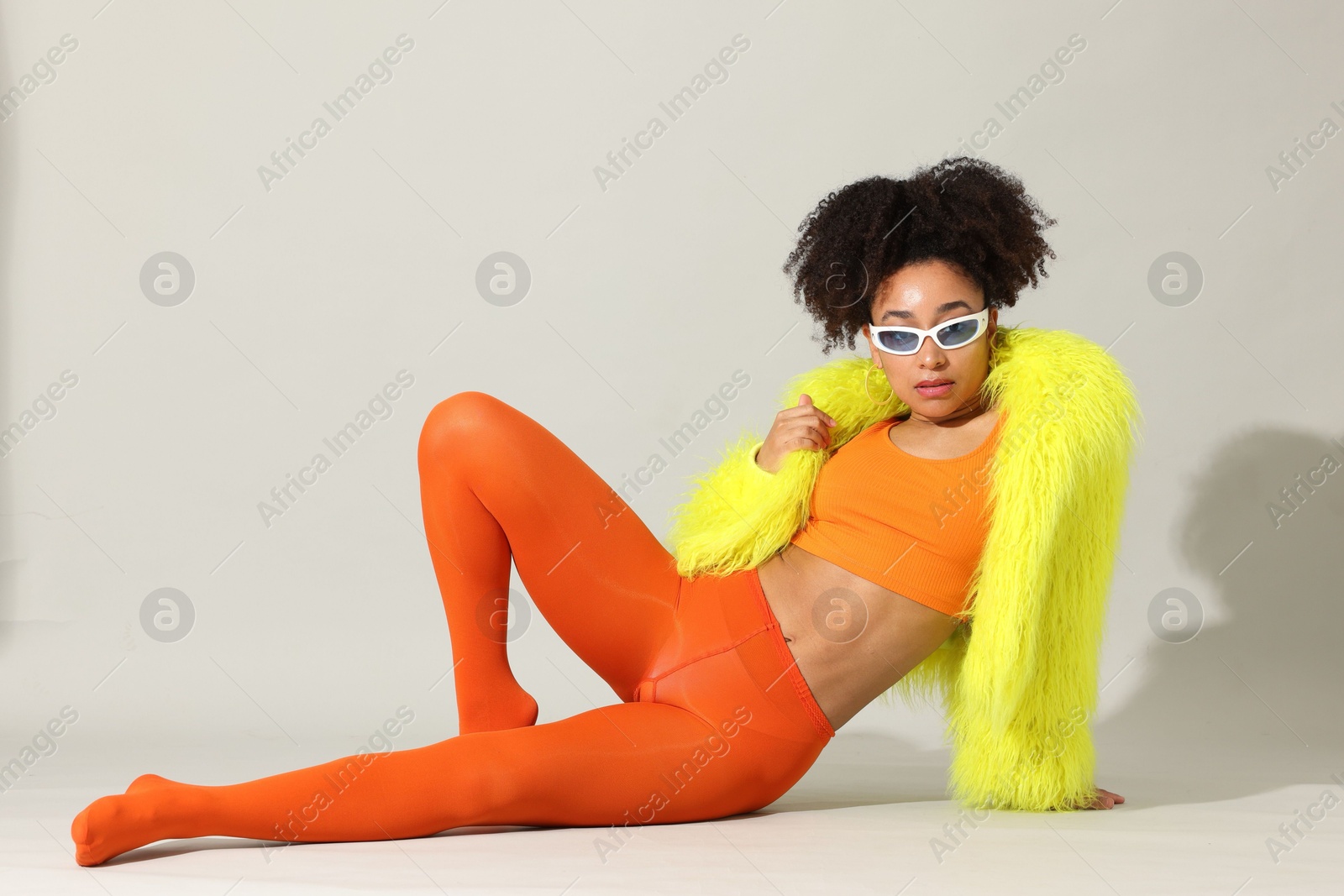 Photo of Fashionable portrait of beautiful Brazilian woman in stylish outfit on white background