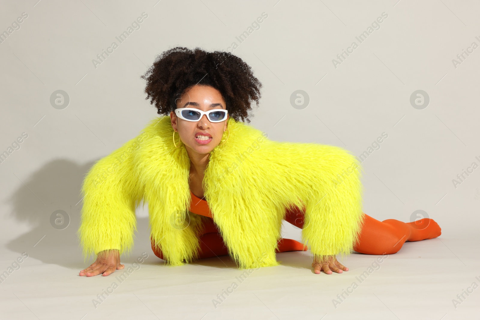Photo of Fashionable portrait of beautiful Brazilian woman in stylish outfit on white background