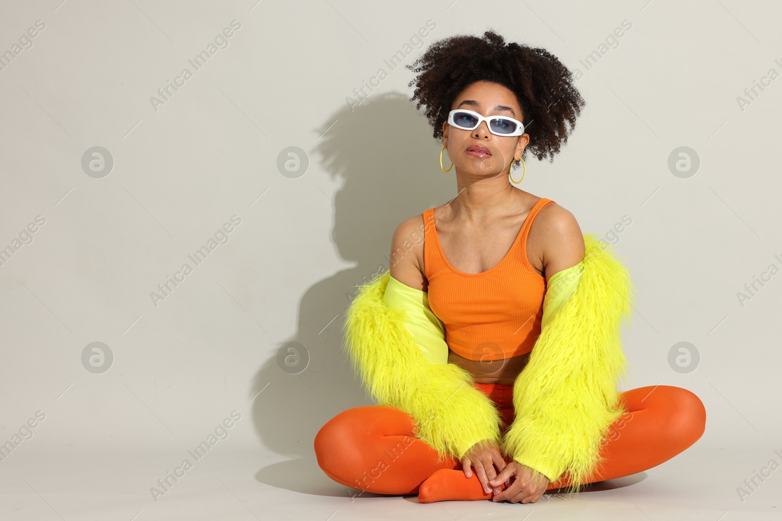 Photo of Fashionable portrait of beautiful Brazilian woman in stylish outfit on white background