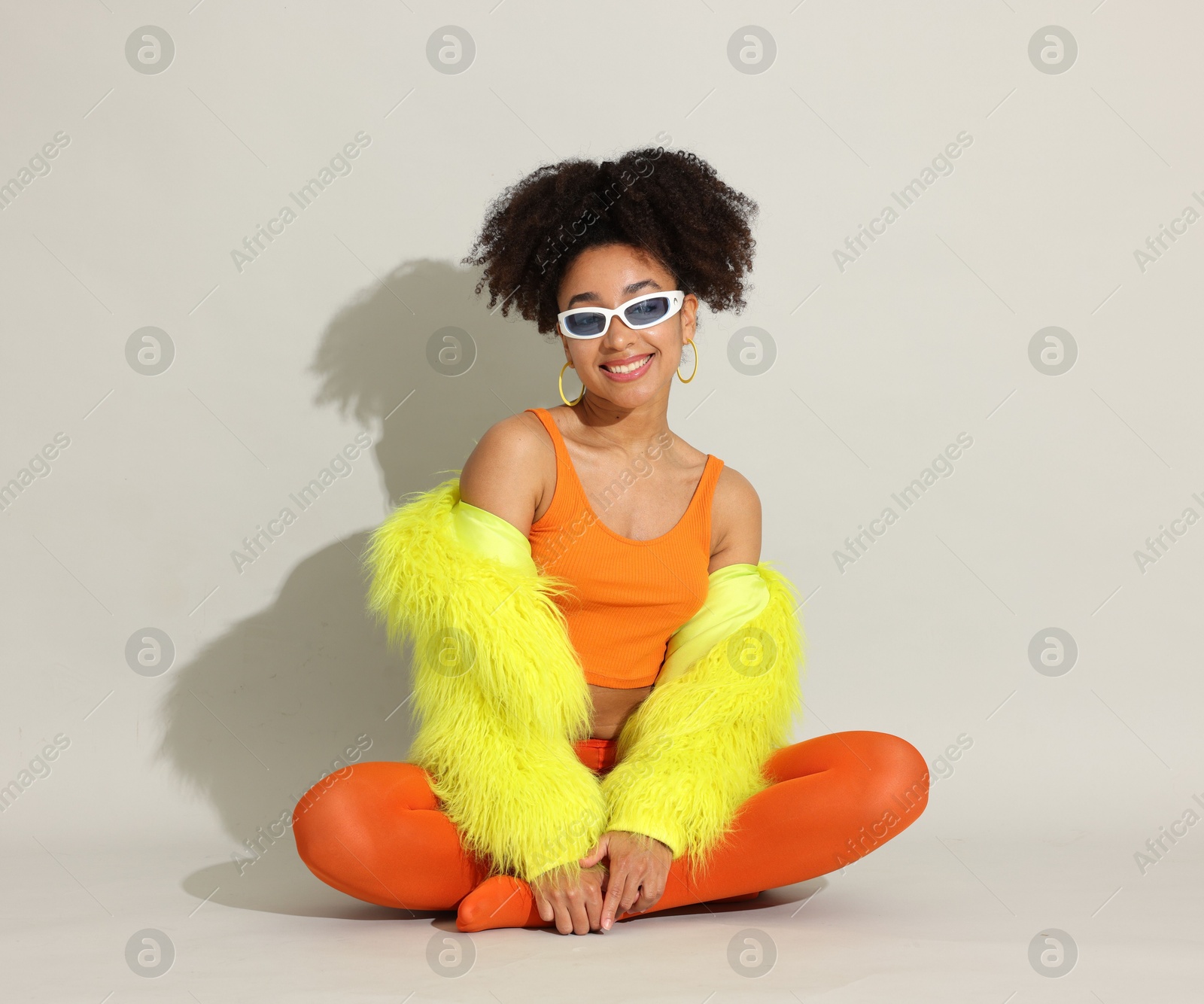 Photo of Fashionable portrait of beautiful Brazilian woman in stylish outfit on white background